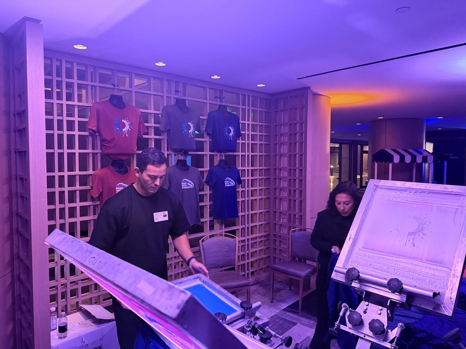 Wall of freshly printed event shirts on display